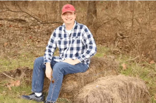 A smiling Walter Green wearing a red baseball cap, representing a new perspective on early retirement and freedom.